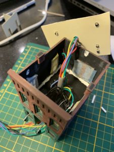 A drinking straw used as conduit, to prevent loose wires from being seen through the archway between the front and back of the store.