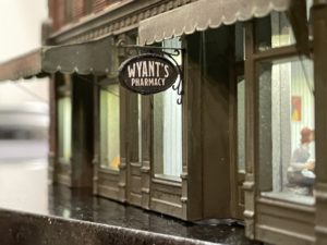 Pharmacy sign made of wood and paper.