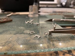 Assembling cast metal barber chairs for the salon.