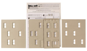 The kit comes with four walls, two chimneys, and some styrene for the roof and windows.