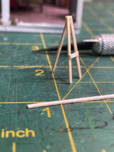 Easel partially constructed from scale lumber.