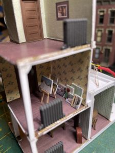 Painting room with easel and canvases.