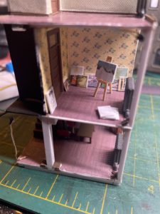 Painting room with canvases and easel.