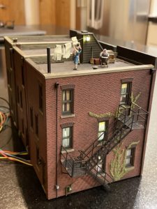 Rooftop laundry scene with other buildings.